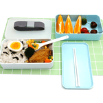 bento lunchbox compartitioned with food